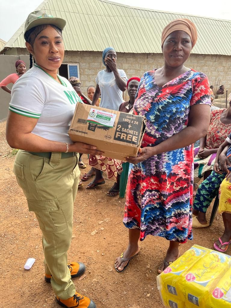 Founder distributing household packages to community women